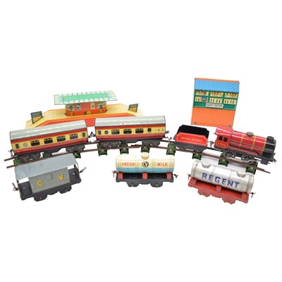 Lot 378 - Chad Valley O gauge model railway clockwork locomotive, with coaches, wagons and accessories.