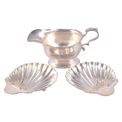 Lot 226 - Scottish silver sauce boat and a pair of silver shell dishes