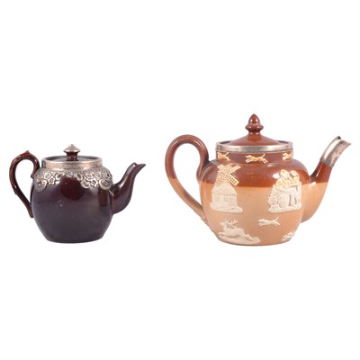 Lot 99 - Royal Doulton stoneware teapot, silver mounted, and a treacle-glazed teapot
