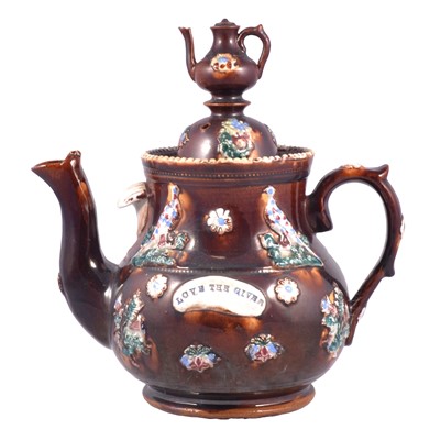 Lot 108 - Bargeware teapot, 'Love the Giver', and a treacle-glazed 'Mr Punch' teapot