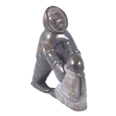 Lot 150 - An Inuit carving of an Eskimo building a wall