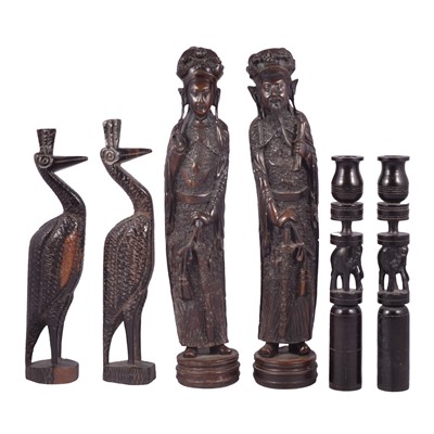 Lot 108 - Two pairs of carved figures and a pair of carved ebony candlesticks.