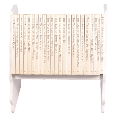 Lot 146 - Set of twenty three Peter Rabbit Books, in a themed book rack