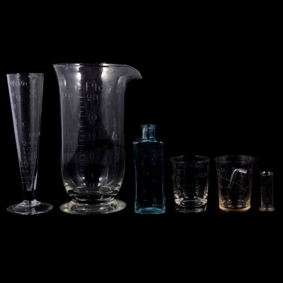 Lot 132 - Collection of measuring glasses and eye baths, ceramic and glass.