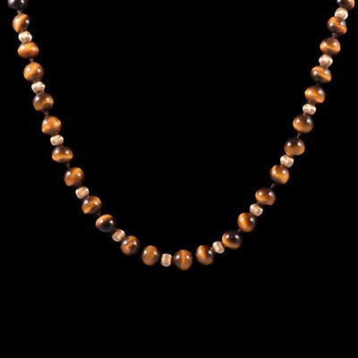 Lot 334 - A tiger's eye and gold-coloured bead necklace.