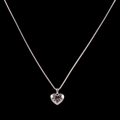 Lot 291 - A platinum heart pendant on a chain.