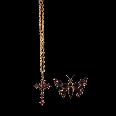 Lot 263 - A garnet set cross pendant on a chain, and a garnet set butterfly brooch.
