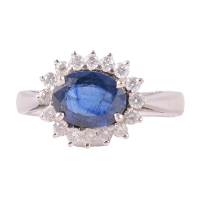 Lot 5 - A sapphire and diamond cluster ring.