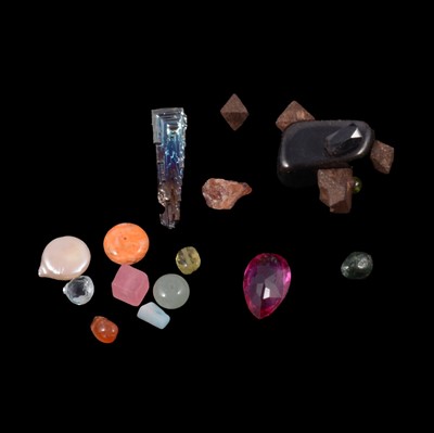 Lot 341 - A collection of rough gemstone crystals, faceted and polished gemstones.