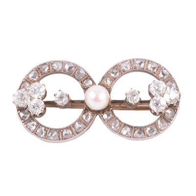 Lot 224 - A diamond and pearl double circle brooch.