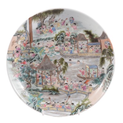 Lot 9 - Chinese porcelain polychrome dish with playful figures in a garden, Qing dynasty