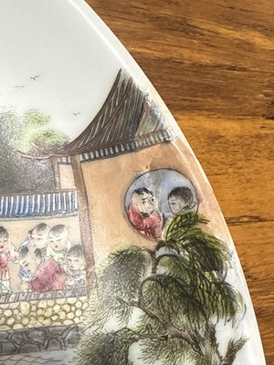 Lot 9 - Chinese porcelain polychrome dish with playful figures in a garden, Qing dynasty