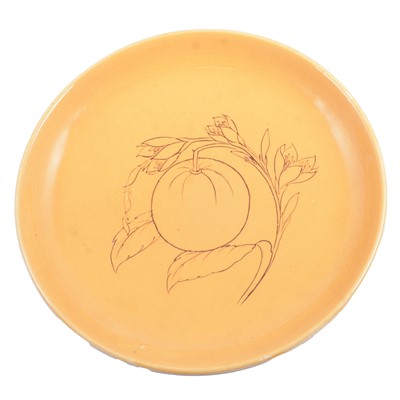 Lot 17 - Walter Moorcroft, an ochre coloured charger with tube line fruit decoration.