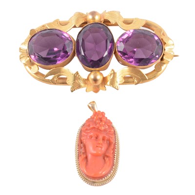 Lot 176 - A Victorian purple paste brooch, and a carved coral cameo pendant.