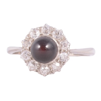 Lot 38 - An opaque red stone and diamond cluster ring.
