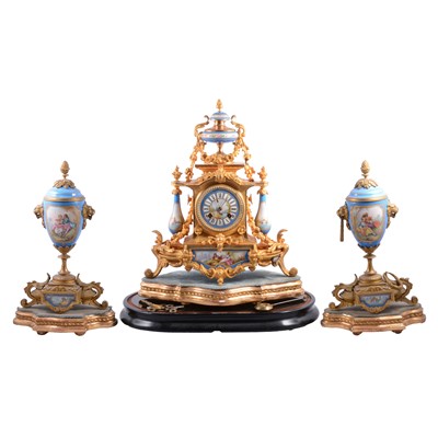 Lot 122 - Late 19th century French gilt spelter and porcelain mantle clock, and a pair of associated blue celeste vases, on plinths.