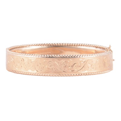 Lot 208 - A 9 carat yellow gold half-hinged bangle.
