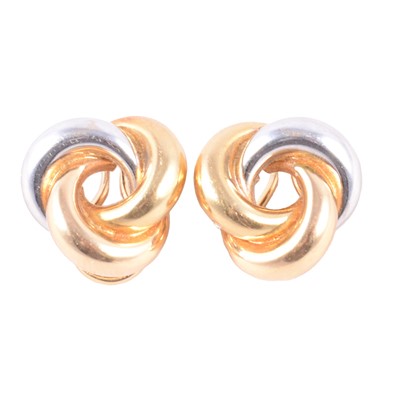Lot 243 - A pair of 18 carat yellow and white gold knot earclips.