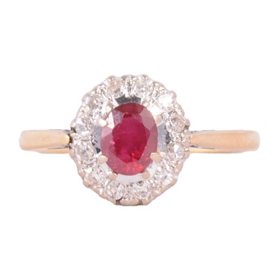 Lot 12 - A ruby and diamond cluster ring.