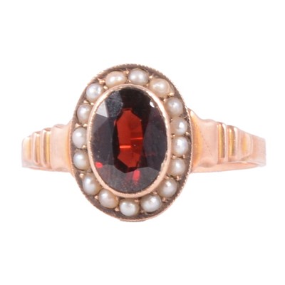 Lot 28 - A garnet and seed pearl cluster ring.