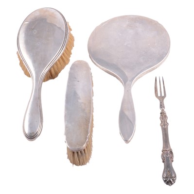 Lot 468 - A silver-backed hand mirror and brush, another brush, and a pickle fork.