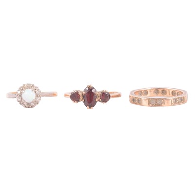 Lot 49 - Three gemset rings, opal and diamond, garnet, synthetic white stone.