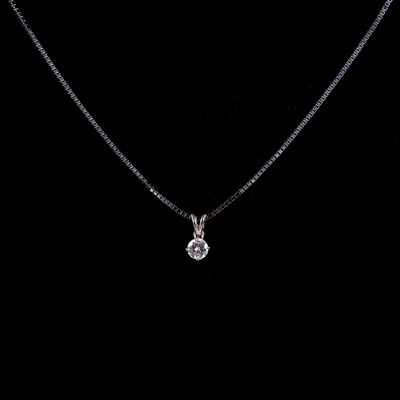 Lot 255 - A diamond solitaire pendant on a chain.