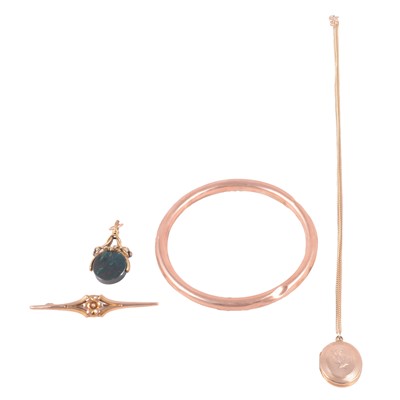 Lot 150 - A gold upper arm bangle, bloodstone fob, yellow metal bar brooch, and gold-plated locket on a chain.