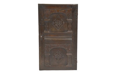 Lot 339 - A single antique oak cabinet door with carved detail, escutcheon and hinges.