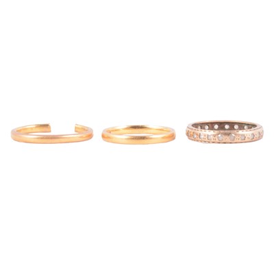 Lot 118 - Two 22 carat gold wedding bands, and a synthetic white stone full eternity ring.