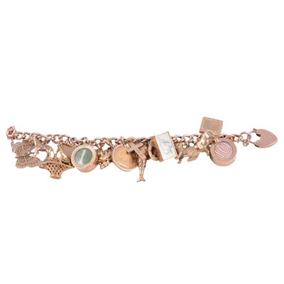 Lot 229 - A 9 carat yellow gold charm bracelet with charms attached.