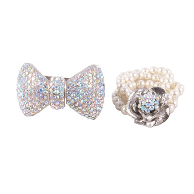 Lot 521 - Butler & Wilson - a bow design half-hinged bangle, and a faux pearl bracelet.