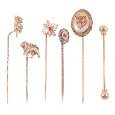 Lot 357 - Six stick pins, and a gold-plated collar bar.