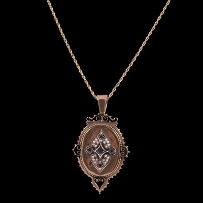 Lot 258 - A sapphire and seed pearl mourning locket / pendant on a chain.