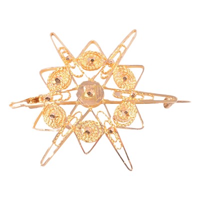 Lot 195 - A yellow metal six ray star brooch.
