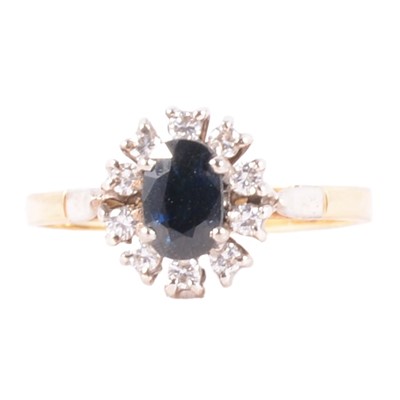 Lot 6 - A sapphire and diamond cluster ring.