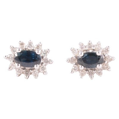 Lot 242 - A pair of sapphire and diamond earstuds.