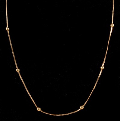 Lot 300 - A yellow metal chain and bead necklace.