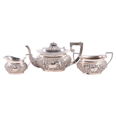 Lot 242 - A silver repouse chased three piece teaset, Birmingham 1903.