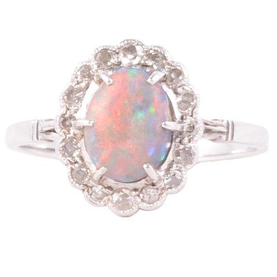 Lot 32 - A black opal and diamond cluster ring.