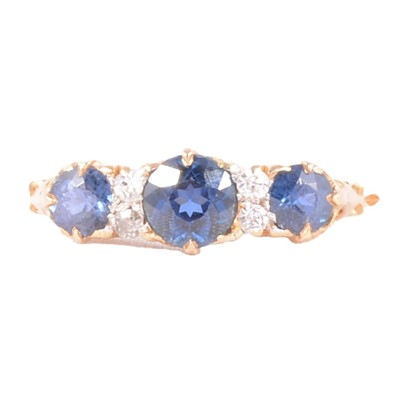 Lot 2 - A sapphire and diamond half hoop ring.