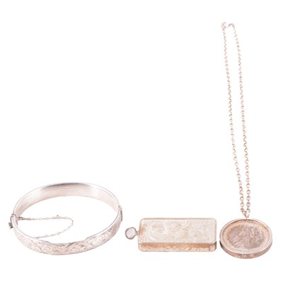 Lot 465 - A silver ingot, half-hinged bangle, and Italian coin pendant on a chain.