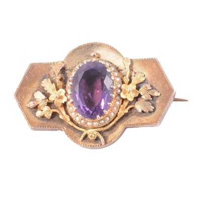 Lot 175 - A Victorian yellow metal brooch with amethyst and seed pearl cluster to centre.