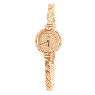 Lot 439 - Omega - a lady's 18 carat yellow gold quartz bracelet wristwatch.