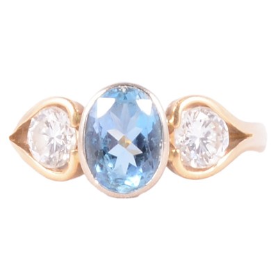 Lot 22 - An aquamarine and diamond three stone ring.