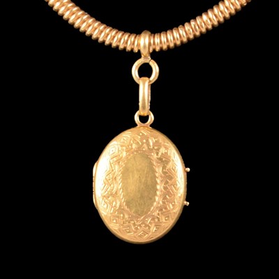 Lot 283 - A yellow metal locket on a collar.
