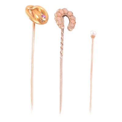 Lot 385 - Three yellow metal gemset stick pins.