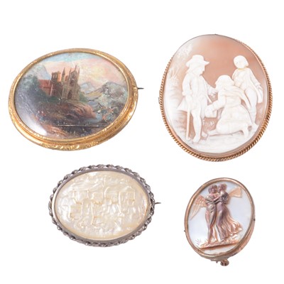 Lot 203 - An oval carved shell cameo brooch and three other scenic brooches.