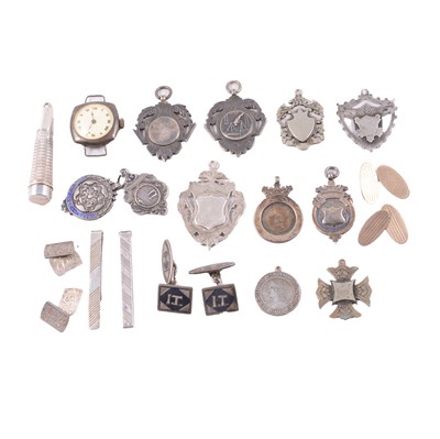 Lot 437 - A collection of silver, white metal and metal shield fobs, cufflinks, tieclips, and cheroot holder.