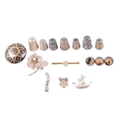 Lot 477 - A collection of silver, white metal and metal charms, bag charms, thimbles, pique brooch.